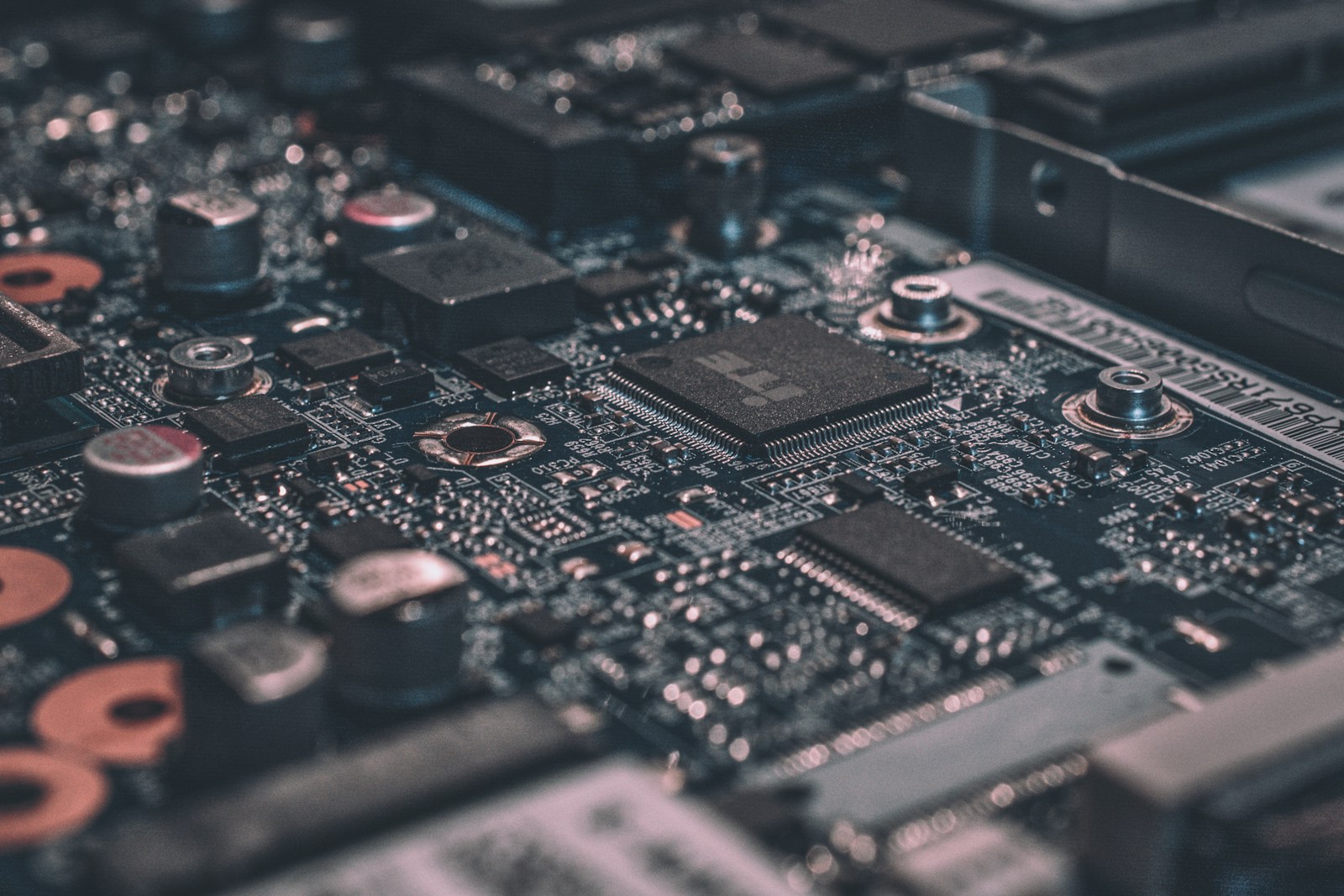 Close-up of a laptop motherboard, capacitors, BGA chips and traces