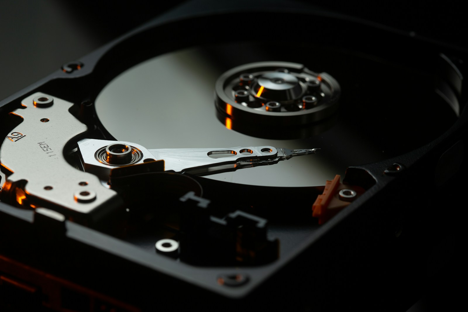 Inside a hard drive showing read/write head and platter